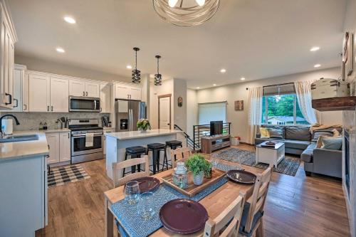 a large kitchen and living room with a table and chairs at Lake Stevens Getaway 2 Decks with River Views in Lake Stevens