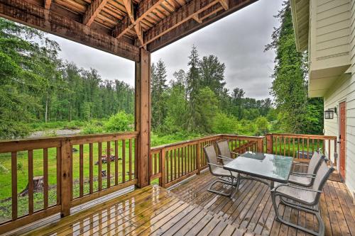 a patio with a table and chairs on a deck at Lake Stevens Getaway 2 Decks with River Views in Lake Stevens
