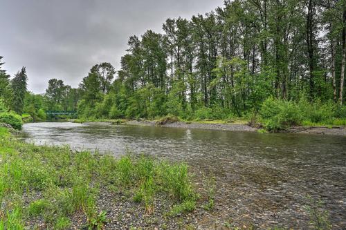 a river with rocks and trees on the side at Lake Stevens Getaway 2 Decks with River Views in Lake Stevens