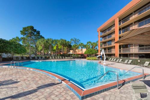 a large swimming pool in front of a building at Rosen Inn Lake Buena Vista in Orlando