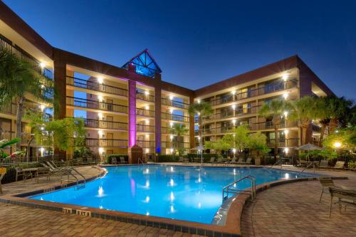 a pool in front of a hotel at night at Rosen Inn Lake Buena Vista in Orlando