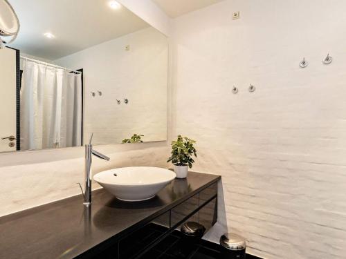 a bathroom with a bowl sink on a counter at Apartment Skagen XV in Skagen