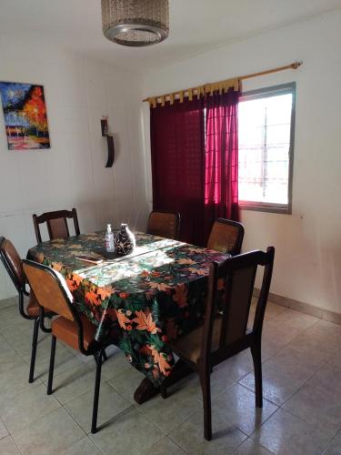 a dining room table with a floral table cloth on it at Residencia Don Roque in Santa Rosa