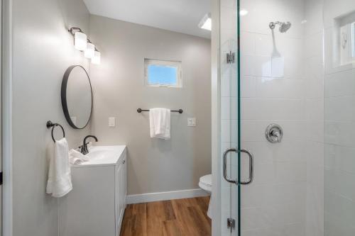 a bathroom with a shower and a sink and a mirror at Mission Bay Vista in San Diego