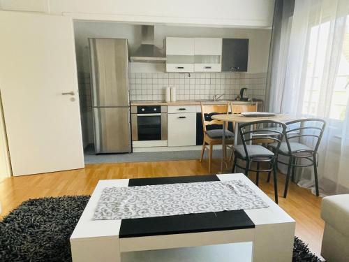 ein Wohnzimmer mit einem Tisch und einer Küche in der Unterkunft Bei Daniel am Dortmunder Flughafen in Dortmund