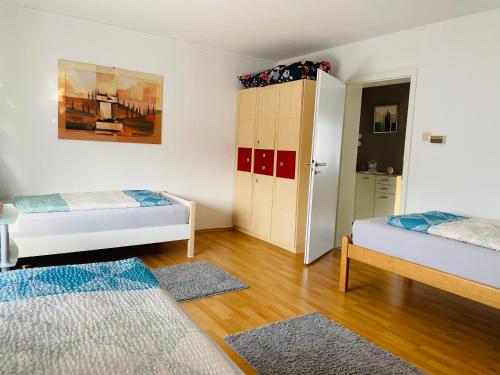 1 dormitorio con 2 camas, armario y puerta en Bei Daniel am Dortmunder Flughafen en Dortmund