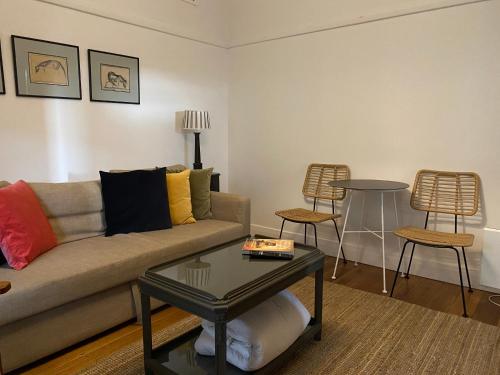 a living room with a couch and a table at Aashay Country Stay in Fish Creek