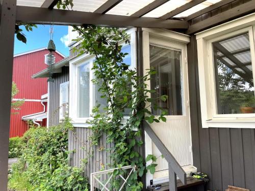a house with a vine growing up the side of it at 4 person holiday home in LINKÖPING-By Traum in Linköping