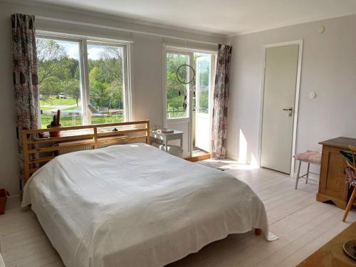 a bedroom with a large bed and a large window at Holiday home LINKÖPING II in Linköping