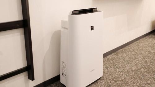 a white refrigerator sitting next to a wall at Via Inn Shinagawa Oimachi in Tokyo
