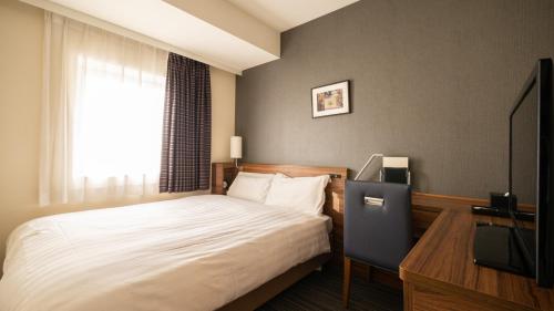 Postel nebo postele na pokoji v ubytování Via Inn Shinagawa Oimachi