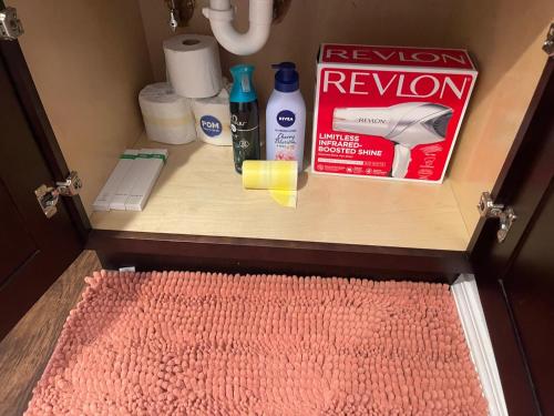 a bathroom cabinet with a drawer with a red rug at OU-2 bed 2 bath apartment close to OU in Oklahoma City