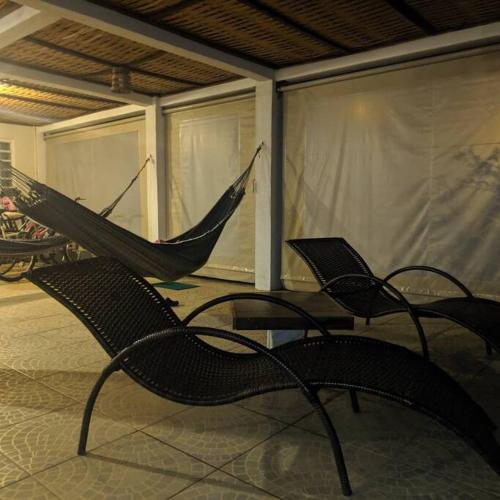 two hammocks sitting on a screened in porch at Recanto do sossego!! in Morretes