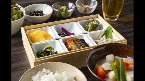 a wooden box filled with different types of food at Via Inn Umeda in Osaka