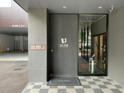 a lobby of a building with a walk in window at Via Inn Hakataguchi Ekimae in Fukuoka
