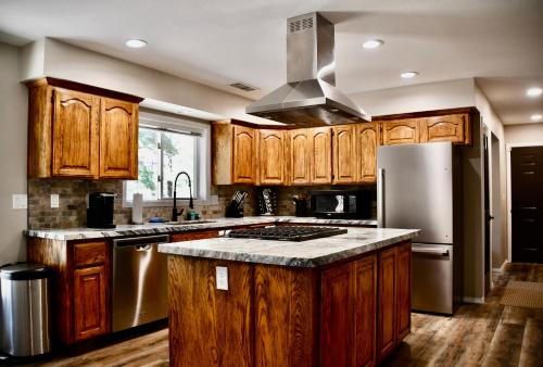 a kitchen with wooden cabinets and a stainless steel refrigerator at Glenwood Pines in Flagstaff