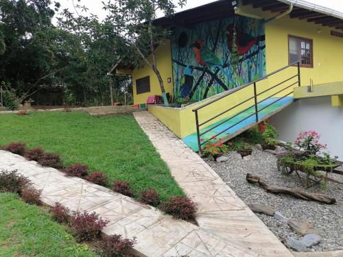 a house with a painting on the side of it at Finca Hotel La Vida es un Paseo in San Carlos