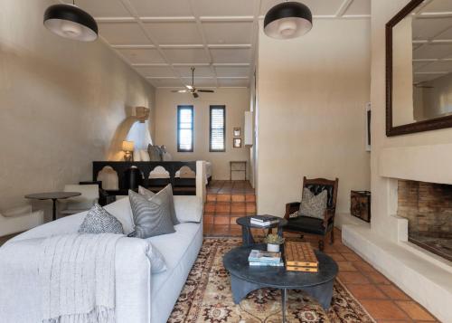 a living room with a white couch and a fireplace at Tower Lodge in Pokolbin