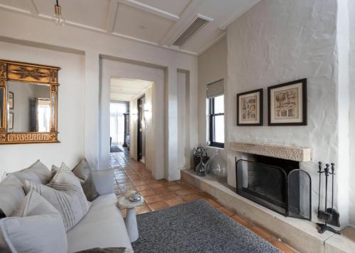 a living room with a couch and a fireplace at Tower Lodge in Pokolbin