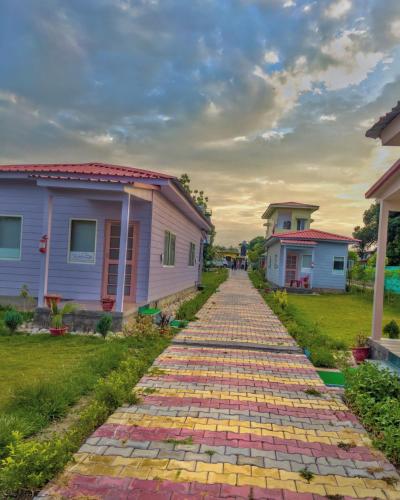 a cobblestone road in front of some houses at Corbett VEDA INN in Rāmnagar