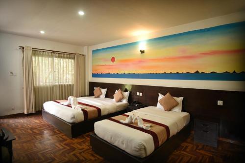 Postel nebo postele na pokoji v ubytování Hotel Thamel Park