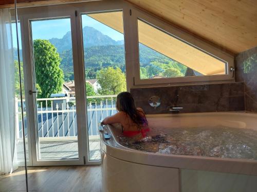a woman sitting in a bath tub in a house at Wellness & Landhotel Prinz- Wellness & Romantik in Anger