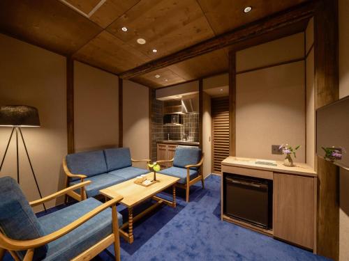 a living room with two chairs and a table at THE MACHIYA KAZAHAYA in Kyoto