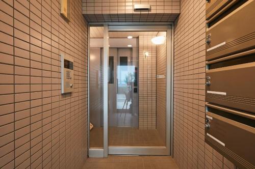 a hallway with a glass door in a building at Keigen building in Yokohama