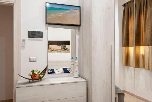 a living room with a television on a wall at da Rocco B&B in Sant'Isidoro