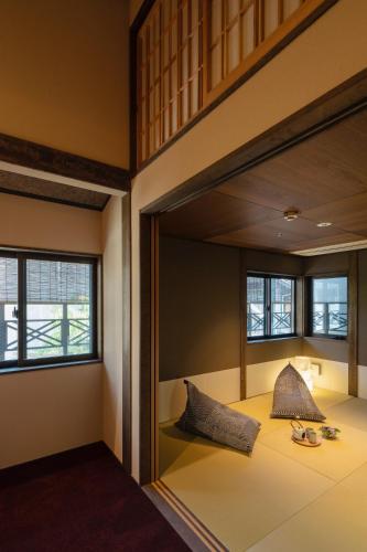 a room with a bed with two pillows on it at THE MACHIYA KAZAHAYA in Kyoto