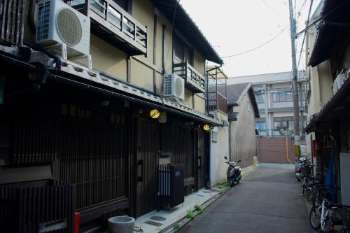 an alley with a motorcycle parked next to a building at TABITABI KANOE HARA in Kyoto