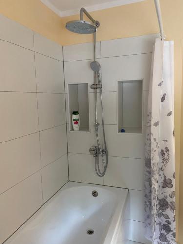 a bathroom with a shower and a bath tub at 9 Mežmalas iela in Jūrmala