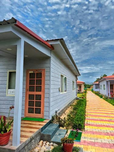 a house with a pathway in front of it at Corbett VEDA INN in Rāmnagar