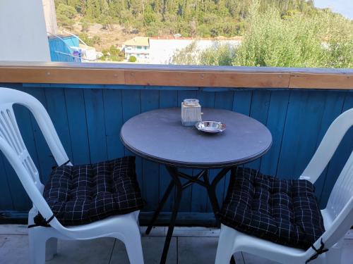 a small table with two chairs and a bowl on it at IRIS STUDIOS in Agios Nikitas