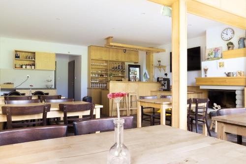 a dining room with tables and chairs and a fireplace at penzion Valentino in Bedřichov