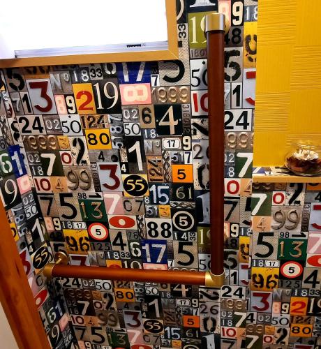 a wall filled with lots of different types of numbers at 一棟丸ごと・YOURSとなり in Osaka