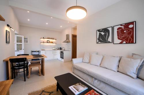 a living room with a couch and a table at Plinthos Residence in Kavala