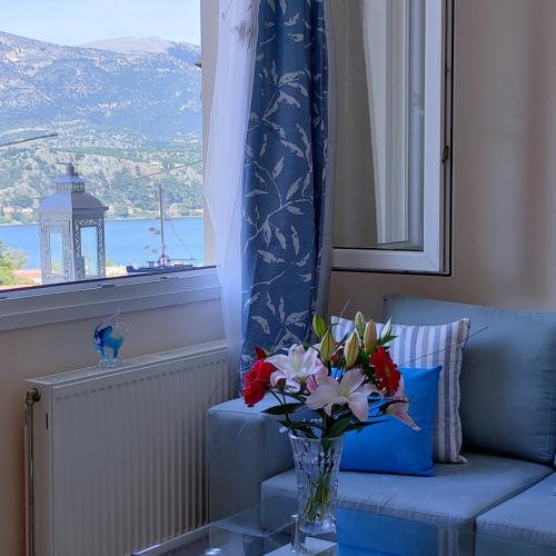 a vase of flowers on a table in a living room at Blue Lagoon Luxury Apartment A1 in Argostoli