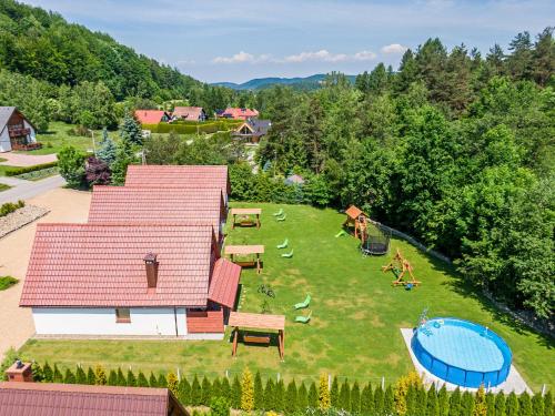 an aerial view of a backyard with a swimming pool at Domki Pod Czarnym Groniem in Rzyki