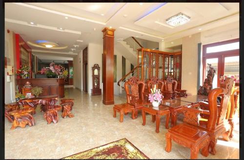 a dining room with wooden chairs and a table at Kim Ngoc Khanh Hotel in Tuy Hoa