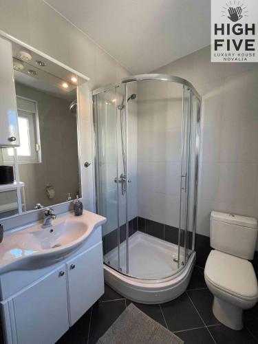 a bathroom with a shower and a sink and a toilet at Apartment High Five Novalja in Novalja