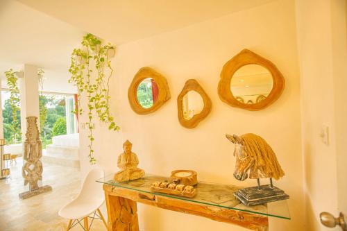 a room with a table and mirrors on the wall at Villa Cella Bella Ubud in Ubud