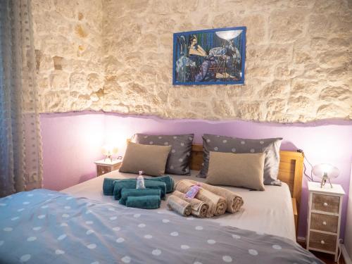 a bedroom with a bed with pillows on it at ~Melody Room ~ with Breezy & Silent Ambience in Hvar