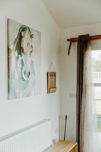 a painting of a horse on the wall of a room at King Richard's Luxury Lodge - Sleeps up to 8, Dog Friendly, Near Sherwood Forest at Fairview Farm in Nottingham set in 88 acres and great for Groups, Family Gatherings & Corporate events in Nottingham