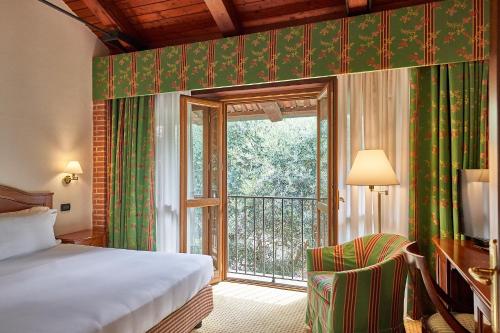 a hotel room with a bed and a window at Relais Santo Stefano in Sandigliano