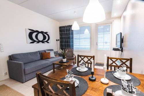 a living room with a couch and a table at Holiday In Lapland - LeviStar II 312 in Levi