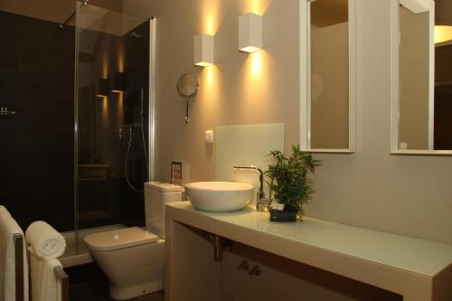 a bathroom with a sink and a toilet at Castilho House in Lisbon