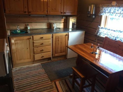 a kitchen with wooden cabinets and a wooden counter top at Hestdalssetra in Dovre