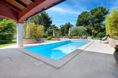 an image of a swimming pool in a yard at Apartments Villa Rossella 1 in Rovinj