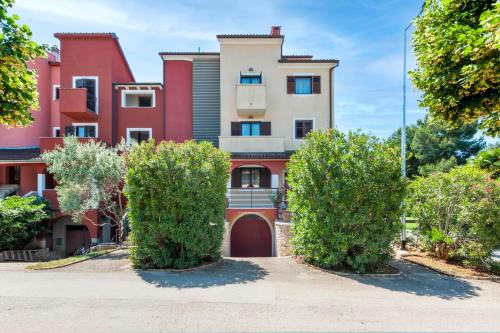 a building with two trees in front of it at Apartments Villa Rossella 1 in Rovinj